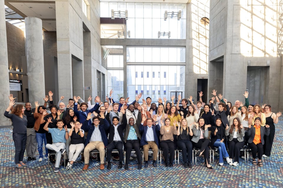 2024 IFPA Jay Pack Award Winners sitting and standing in a group while smiling and waving