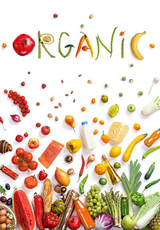 A variety of organic foods, including fruits, vegetables, and other items, arranged with the word "ORGANIC" spelled out at the top.