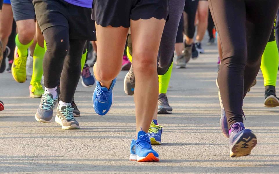 Feet of people running a 5k race. 